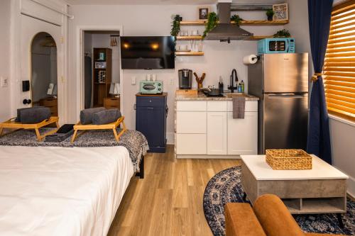 a bedroom with a bed and a kitchen with a refrigerator at The 1888 Hotel in St Petersburg