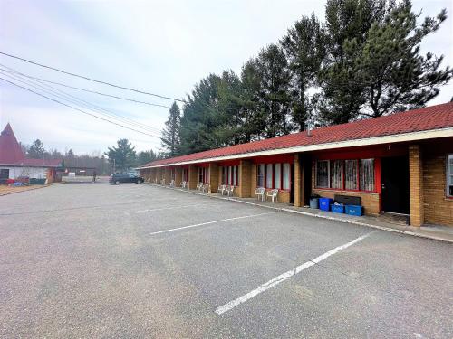 a car is parked in front of a building at Red Top Motor Inn in Iron Bridge