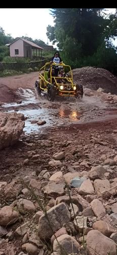 a person riding a four wheeler on a rocky road at HOSTEL BRISAS in Torotoro