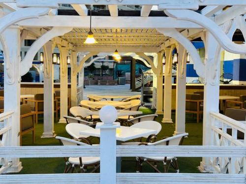 a group of tables and chairs in a building at Porto Sokhna Hotel in Ain Sokhna