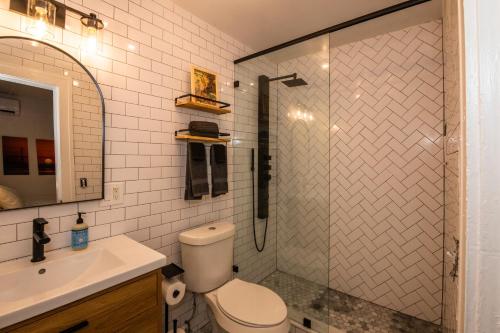 a bathroom with a shower with a toilet and a sink at The 1888 Hotel in St. Petersburg