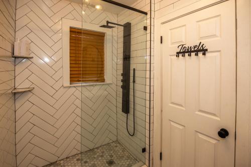 a shower with a glass door in a bathroom at The 1888 Hotel in St Petersburg