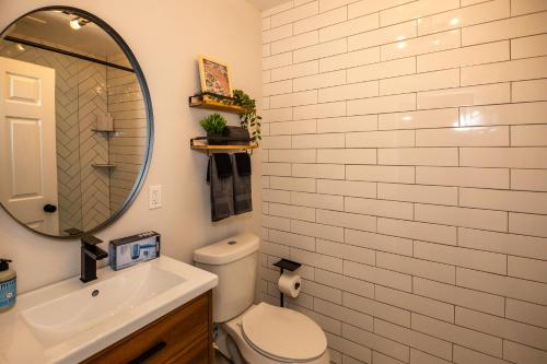 a bathroom with a toilet and a sink and a mirror at The 1888 Hotel in St Petersburg