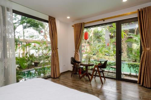 a bedroom with a bed and a table and chairs at King Kong Homestay in Ninh Binh