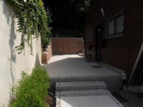 a walkway leading to a building with stairs next to it at Ferienhaus in Kuhklingen mit Großer Terrasse in Wald-Michelbach