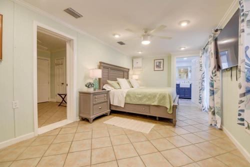 a large bedroom with a bed and a hallway at Heron House by Brightwild - Luxury Waterfront Home in Key West