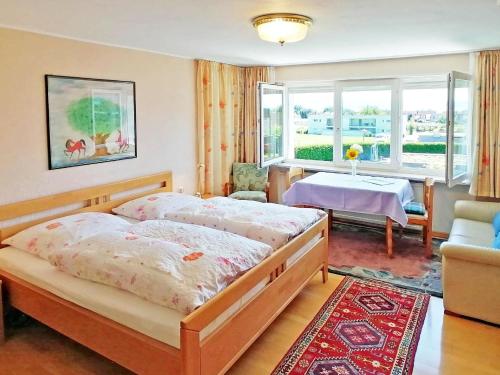 Haus Kees, Kressbronn am Bodensee-Apartment mit Kleinküche - b48619 في كريسبرون ام بوندنس: غرفة نوم بسرير وطاولة ونافذة