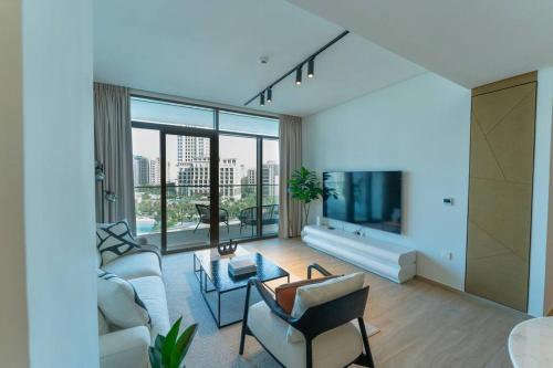 a living room filled with furniture and a large window at The Palace I Luxury 2BD I Dubai Creek Harbour in Dubai
