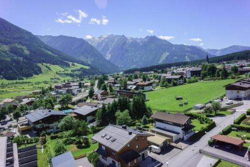 una pequeña ciudad en las montañas con un campo verde en Penthouse am Sonnenhang en Neukirchen am Großvenediger