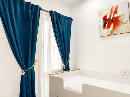 a blue curtain in a room with a window at Modern 7-Pax Retreat Steps from IOI City Mall in Serdang