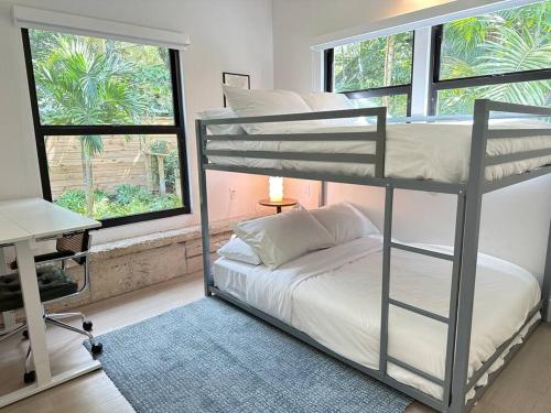 a bedroom with a bunk bed and a window at Coconut Grove Mid-Century Jungle Oasis in Miami