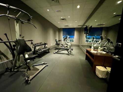 a gym with several treadmills and exercise bikes at Southfort Inn in Fort Saskatchewan