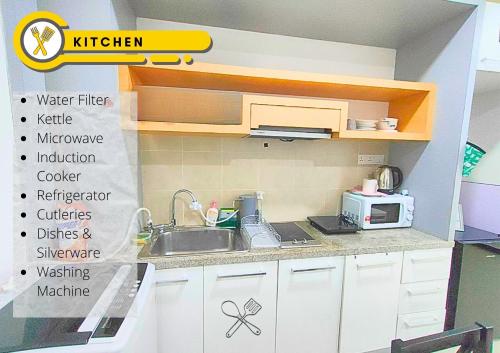 a small kitchen with a sink and a microwave at Cozy Stay at Shaftsburry, Urban Convenience #SH1 in Cyberjaya