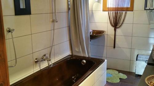 a bathroom with a bath tub and a sink at Ferienhaus für 2 Personen ca 70 qm in Wolfsberg, Kärnten Saualpe in Wolfsberg