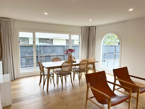 a dining room with a table and chairs at Carterley House in Christchurch