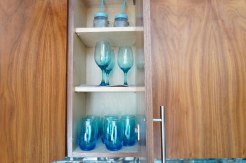 a cupboard with blue glasses and blue dishes in it at Cielomar in Tijuana