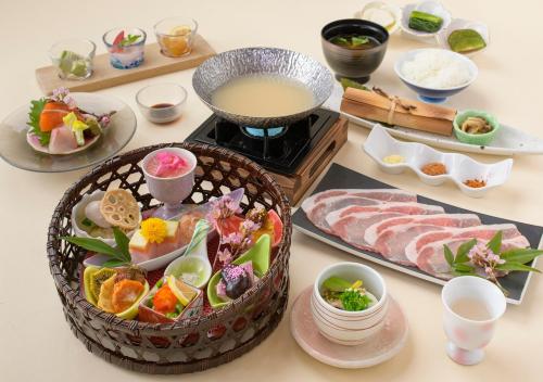 a table topped with plates of food and sushi at Uematsuya in Ueda