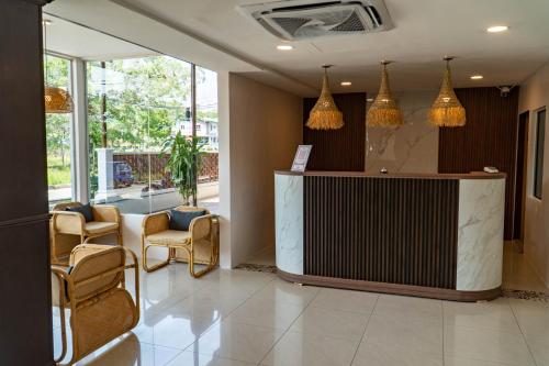 a waiting room with chairs and a reception desk at Mulyo Hotel in Port Dickson
