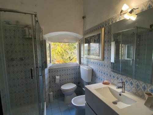 a bathroom with a toilet and a sink and a shower at Luxury Retreat Montevettolini in Montevettolini