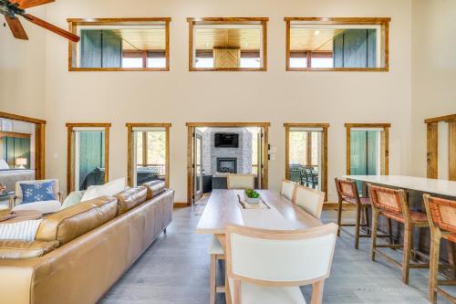 a living room with a couch and a table at Broken Bow Cabin about 5 Mi to State Park with Hot Tub! in Broken Bow