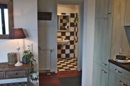 a bathroom with a sink and a bathroom with a mirror at Appartement in Sasbach Am Kaiserstuhl mit Grill in Sasbach am Kaiserstuhl