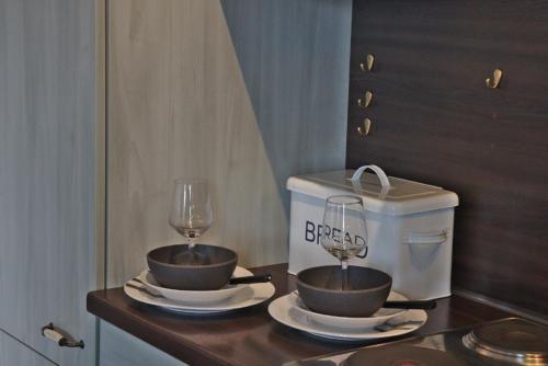 a table with two bowls and a wine glass at Appartement in Sasbach Am Kaiserstuhl mit Grill in Sasbach am Kaiserstuhl