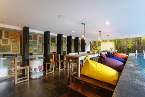 a restaurant with tables and chairs in a room at Horison Ultima Seminyak Bali - CHSE Certified in Seminyak
