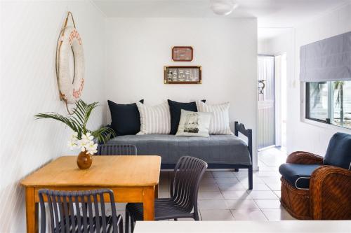 a living room with a couch and a table at Seaspray Yeppoon in Yeppoon