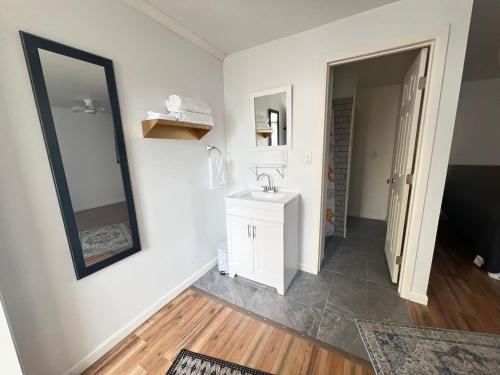 a bathroom with a sink and a mirror at LittleBetty's LandingPad in Torrance