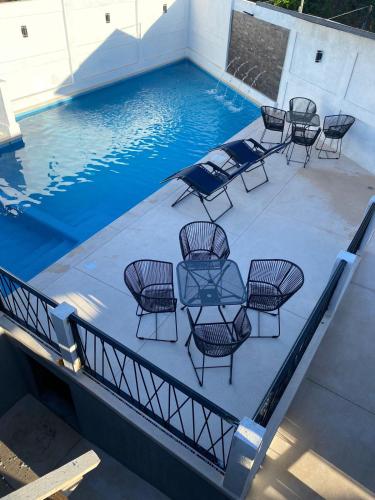 a table and chairs sitting on a patio next to a swimming pool at Lofts Terra Nuevo Vallarta in Nuevo Vallarta