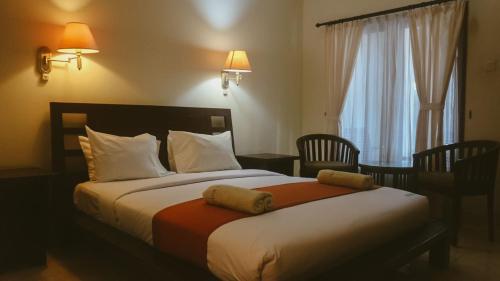 Postel nebo postele na pokoji v ubytování New Puri Asih Hotel