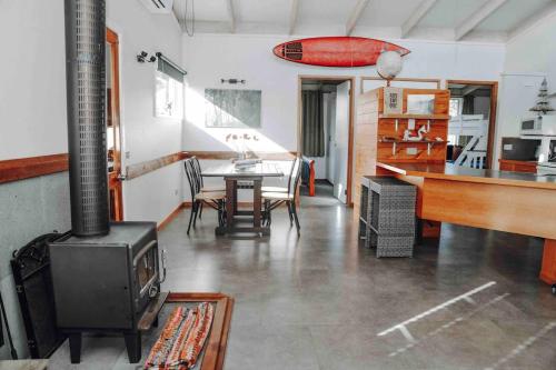 a living room with a stove and a table at The PC Cottage in Port Campbell