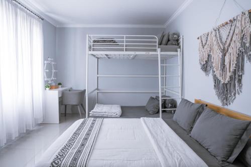 a bedroom with a bunk bed and a couch at Brownies House in Bandung