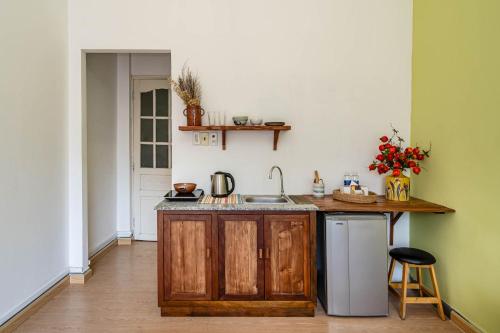 a kitchen with a sink and a counter at HoLo Fairy House Saigon - Serviced Homestay in Ho Chi Minh City