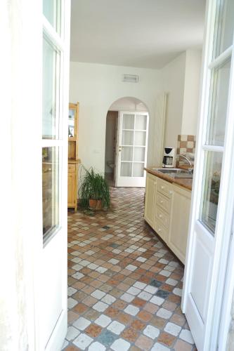 a kitchen with a tiled floor and a large doorway at Hotel Sole Holiday in Arco