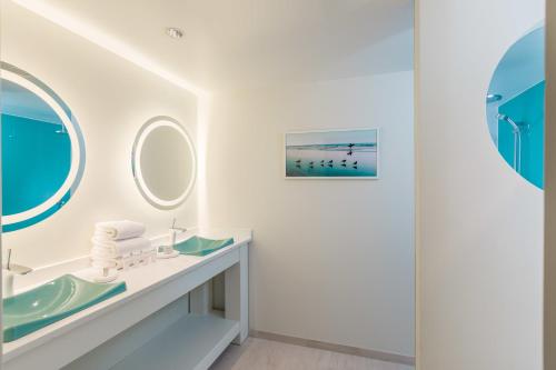 a bathroom with a sink and a mirror at The Break Hotel in Narragansett