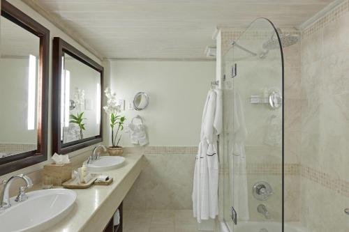 a bathroom with two sinks and a shower at Colony Club, a Luxury Collection Resort, Barbados in Saint James