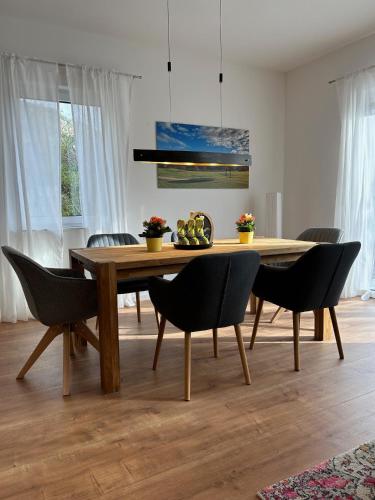 a dining room with a wooden table and chairs at Ferienhaus Baron mit eigener Sauna in Marquartstein