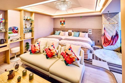 a bedroom with two beds and a couch at Hotel BaliAn Resort Shinjuku Glamping in Tokyo