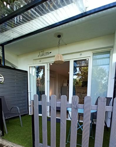 a dining table and chairs on the patio of a house at Le studio 27 in Le Tampon