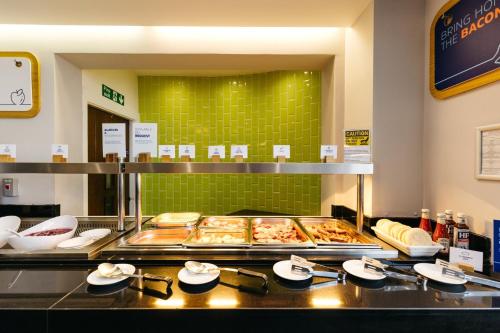 a buffet line with many different types of food at Holiday Inn Express London Heathrow T5 by IHG in Slough