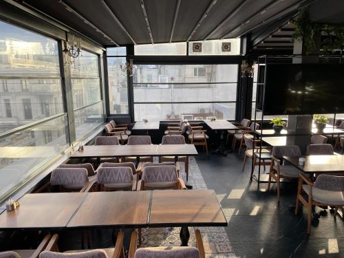 a restaurant with tables and chairs and a large window at Burj Al Istanbul in Istanbul