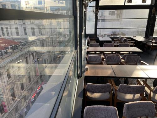 a restaurant with tables and chairs and a window at Burj Al Istanbul in Istanbul