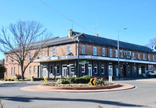 a large brick building with a roundabout in front of it at Clubhouse Hotel Yass in Yass