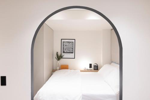 a bedroom with two beds under an archway at Urban Folks Svolou in Thessaloniki