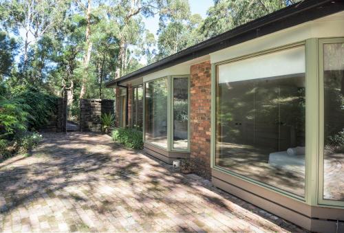 a house with large windows on the side of it at Elliott Lodge - Getaway for the whole family/pets in Upwey