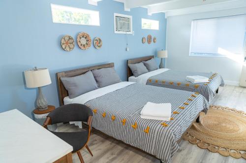 two beds in a room with blue walls at Private Villa with Pool and Sauna in Dania Beach