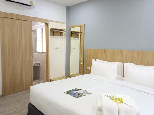 a large white bed in a hotel room at Beyond 21 Hotel in Khon Kaen