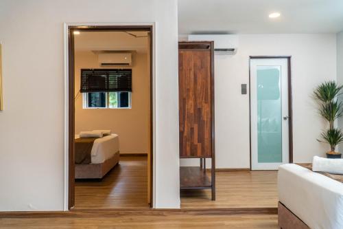 a living room with a bed and a mirror at Mulyo Hotel in Port Dickson