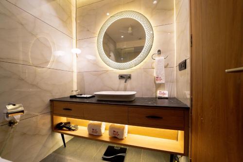 a bathroom with a sink and a mirror at Pink Mango A Boutique Hotel in Hisār